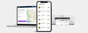 laptop and mobile phone with Rollo Ship dashboard on screen next to rollo wireless label printer.